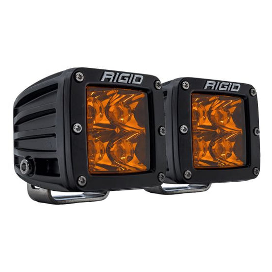 Two Rigid Industries D-Series Pro Amber Spot pattern pod lights on a white background