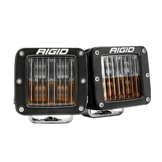 Rigid Industries D-Series Pro SAE LED pod lights with dual-color functionality (clear and amber), compact street-legal housings for on-road and off-road use, shown as a pair on white background.